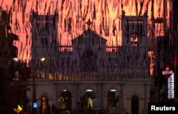FILE - Funeral banners hang across the street in front of St. Anthony's Shrine, days after a string of suicide bomb attacks on churches and luxury hotels across the island on Easter Sunday, in Colombo, Sri Lanka, April 26, 2019.