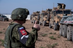 Turkish and Russian patrol is seen near the town of Darbasiyah, Syria, Nov. 1, 2019.