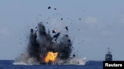 FILE - The Indonesian navy scuttles foreign fishing vessels caught fishing illegally in Indonesian waters near Bitung, North Sulawesi, May 20, 2015. A total of 19 foreign boats from Vietnam, Thailand, Philippines and one from China were destroyed as part of an ongoing crackdown illegal fishing. (Reuters/Fiqman Sunandar/Antara Foto)