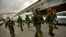 Members of the Military Emergency Unit, walking with special equipment to disinfect areas to prevent the spread of the coronavirus, arrive at Abando train station, in Bilbao, northern Spain, March 23, 2020. 