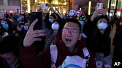 Supporters of the 2022 Beijing Winter Olympics cheer as they mark the start of the 100 days countdown to the opening of the Winter Olympics in Beijing, China, Oct. 26, 2021.
