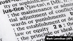 In this December 12, 2018, photo, "justice" is shown in a Merriam-Webster dictionary in New York. 