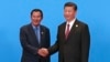 Cambodian Prime Minister Hun Sen, left, and Chinese President Xi Jinping, right, shake hands during the welcome ceremony for the Belt and Road Forum, at the International Conference Center at Yanqi Lake in Beijing, Monday, May 15, 2017. (Roman Pilipey/Pool Photo via AP)
