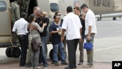 Released foreign aid workers from the Norwegian Refugee Council are welcomed by their colleagues upon arriving at the Wilson airport in Nairobi, July 2, 2012.