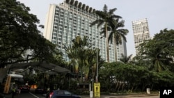 FILE - In this June 2, 2018, file photo, police officers conduct security checks outside the Shangri-la hotel during the 17th International Institute for Strategic Studies (IISS) Shangri-la Dialogue, an annual defense and security forum in Asia, in Singap