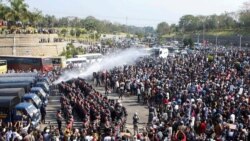 Police fire a water cannon at protesters demonstrating against the coup and demanding the release of elected leader Aung San Suu Kyi, in Naypyitaw, Myanmar, February 8, 2021.