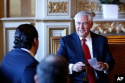 Lebanon's Prime Minister Saad Hariri, left, meets U.S. Secretary of State Rex Tillerson before a gathering of world diplomats in Paris, Dec. 8, 2017.