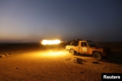 Rebel fighters shoot their weapon towards Syria Democratic Forces (SDF) controlled Tell Rifaat town, northern Aleppo province, Syria October 22, 2016.