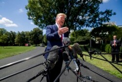 President Donald Trump speaks with reporters on the South Lawn of the White House, Aug. 21, 2019, in Washington.