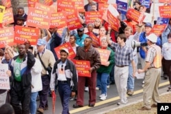 FILE - Demonstrators march to the Florida State Capitol in Tallahassee, Florida, Dec, 13, 2000, during a vote recount in the state following elections which Republican George W. Bush won in electoral votes even though he trailed Democrat Al Gore in the popular vote.