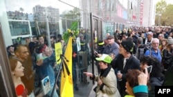 Protesters block the Italie Deux shopping mall in Paris during a demonstration called by the Extinction Rebellion environmental activist movement, Oct. 5, 2019.