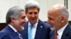 With U.S. Secretary of State John Kerry (C) watching, Afghanistan President Mohammad Ashraf Ghani (R) talks with Afghan Chief Executive Abdullah Abdullah at a NATO foreign ministers meeting in Brussels, Dec. 2, 2014.