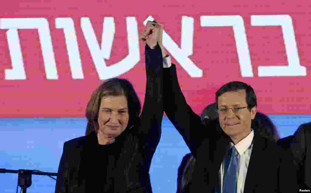 Isaac Herzog and Tzipi Livni, co-leaders of the Zionist Union, raise their arms at party headquarters. Prime Minister Benjamin Netanyahu claimed victory in Israel&#39;s election after exit polls showed he had erased his center-left rivals&#39; lead with a hard rightward shift, Tel Aviv, March 18, 2015.