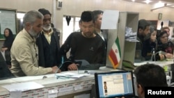 FILE - Afghan refugees submit documents at a refugee center in Tehran, Iran, Oct. 24, 2016. UNHCR estimates that 3 million Afghans are living in Iran.
