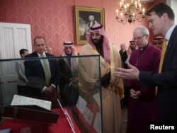 Britain's Archbishop of Canterbury Justin Welby shows The Crown Prince of Saudi Arabia Mohammed bin Salman the Birmingham Koran manuscript - one of the earliest surviving records of the Koran, written in Hijazi, and radiocarbon dated to between 568 and 645 AD - during a private meeting at Lambeth Palace, London, Britain, March 8, 2018.