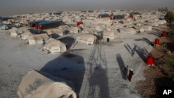 FILE - A view of a refugee camp where Syrians who fled violence have gathered, in Ain Issa town, northeast Syria.