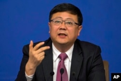 Chinese Environment Minister Chen Jining, shown at a National People's Congress press conference in Beijing, says the country must enforce environmental protections despite the slowing economy, March 11, 2016.