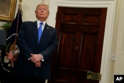 FILE - President Donald Trump listens in the Roosevelt Room of the White House in Washington, Aug. 2, 2017, during an event to unveil legislation that would place new limits on legal immigration.
