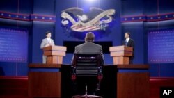 Stand-ins for moderator Jim Lehrer (C), Republican presidential candidate, former Massachusetts Governor Mitt Romney (L) and President Barack Obama (R), run through a rehearsal for the first presidential debate on Wednesday at the University of Denver, in