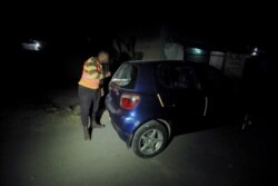 An unarmed vigilante searches a vehicle at a neighborhood in Bole, following Ethiopian Prime Minister Abiy Ahmed's call for citizens to protect their areas from Tigray People's Liberation Front (TPLF), in Addis Ababa, Nov.19, 2021.