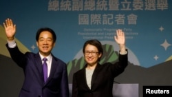 FILE - Taiwan President-elect Lai Ching-te, of Democratic Progressive Party's and his running mate, Hsiao Bi-khim, wave as they hold a press conference, following the victory in the presidential elections, in Taipei, Taiwan Jan. 13, 2024.
