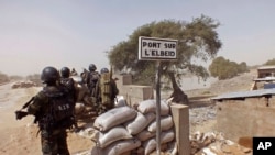 Cameroon soldiers stand guard at a lookout post as they take part in operations against the Islamic extremists group Boko Haram near the village of Fotokol, Feb. 25, 2015.