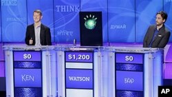 'Jeopardy!' champions Ken Jennings, left, and Brad Rutter, right, look on as an IBM computer called 'Watson' beats them to the buzzer to answer a question during a practice round.