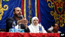 The Brotherhood's Freedom and Justice Party candidate Amr Zaki, left, is speaking to Cairo residents, November 26, 2011.