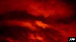 Fire from the Bootleg Fire illuminates smoke at night near Bly, Oregon, on July 16, 2021.