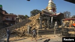 A Nepalese military personnel stands guard inside a compound of Bungamati temple after the earthquake at Bungamati Village, on the outskirts of Kathmandu, Nepal, May 6, 2015. 