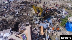 An aerial view shows the evacuation process near a collapsed church after an earthquake in Sigi, south of Palu, Central Sulawesi, Indonesia, Oct. 4, 2018 in this photo taken by Antara Foto. 