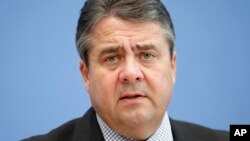 FILE - Sigmar Gabriel speaks during a press conference in Berlin, Nov. 4, 2015. 