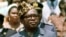 President Mobutu Sese Seko of what was then Zaire watches a military parade in Kinshasa, Zaire, June 1976. Zaire today is the Democratic Republic of Congo (DRC).