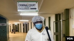  Journalist Hopewell Chin'ono arrives at the Harare Magistrate’s Court on Jan. 9, 2021, in full personal protective equipment (PPE), complaining about his continued 'persecution.' (Columbus Mavhunga/VOA) 