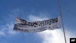 The Taliban flag flies at the Ghazni provincial governor's house, in Ghazni, southeastern, Afghanistan, Aug. 15, 2021. 