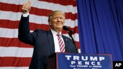 Republican presidential candidate Donald Trump gestures as he arrives to speak at a campaign rally at the Delaware County Fair, Oct. 20, 2016, in Delaware, Ohio. 