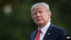 FILE - President Donald Trump walks across the South Lawn of the White House in Washington, Aug. 23, 2017. 