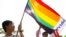 Participants hold a rainbow flag while attending Vietnam's first-ever gay pride parade, Hanoi, Aug. 5, 2012.