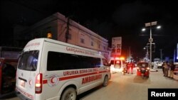 An ambulance is seen at the site of a blast at an ice-cream parlor in Mogadishu, Somalia, Nov. 27, 2020.