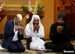 Muslim men pray for victims of the attack at Manchester Arena at a mosque in Manchester, May 23, 2017.
