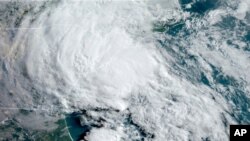 FILE - This May 27, 2020 satellite image made available by the National Oceanic and Atmospheric Administration shows Tropical Storm Bertha approaching the South Carolina coast