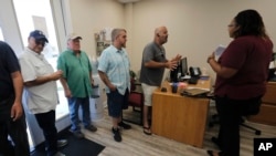 Laid off workers in Louisiana line up for job searches after the steel mill where they worked unexpectedly shut down, Oct. 1, 2019. 