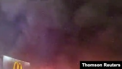 Police vehicle burns during protests after police shooting death of Wallace Jr. in Philadelphia, Pennsylvania.