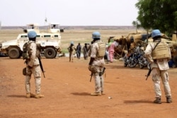 FILE - Senegalese soldiers of the UN peacekeeping mission in Mali (MINUSMA) patrol on foot in the streets of Gao, on July 24, 2019, a day after an attack on an international peace-keeping base in Mali.
