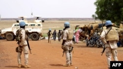 FILE - Senegalese soldiers of the UN peacekeeping mission in Mali (MINUSMA) patrol on foot in the streets of Gao, on July 24, 2019, a day after an attack on an international peace-keeping base in Mali.