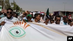 FILE - Protesters chant against military rule and demand the prosecution of former officials, at the Armed Forces Square, in Khartoum, Sudan, April 28, 2019.