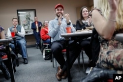 Supporters applaud as they watch President Donald Trump speak at a State of the Union watch party hosted by the Hamilton County Republican Party, Jan. 30, 2018, in Cincinnati.
