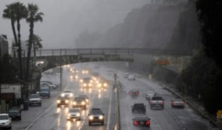 FILE - Motorists drive along Pacific Coast Highway in the rainy weather, Monday, Dec. 20, 2010, in Santa Monica, Calf. (AP Photo/Danny Moloshok)