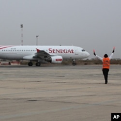 An airport controller directs a Senegal Airlines Airbus at the official launch ceremony for the new airline in Dakar