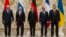 From left, Belarusian President Alexander Lukashenko, Russian President Vladimir Putin, German Chancellor Angela Merkel, French President Francois Hollande and Ukrainian President Petro Poroshenko pose during a break in their peace talks in Minsk, Belarus, Feb. 11, 2015.